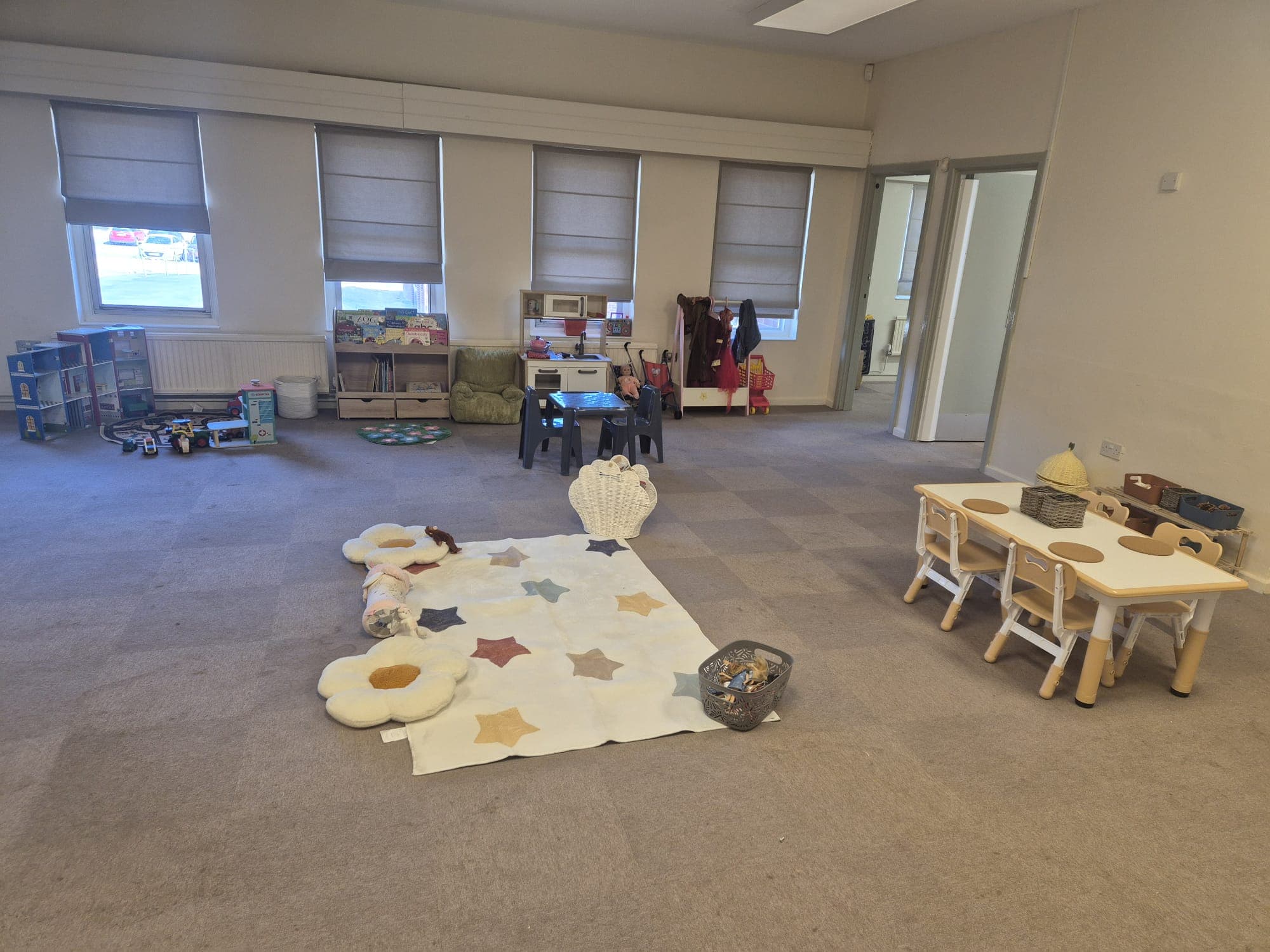 A bright learning and activity space in the main room at Daisy Rose Daycare.